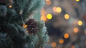 Close-up frosted pine branch with pine cone and glowing Christmas lights as the first snowfall gently falls, creating a warm festive winter holiday atmosphere with soft golden bokeh - Powered by Shutterstock - Get 15% off with code: PIKWIZARD15