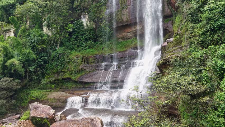 Scenic waterfall in lush, green Colombia evokes tranquility and awe