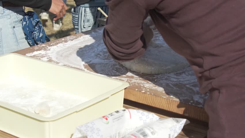 Rolling freshly pounded rice cakes