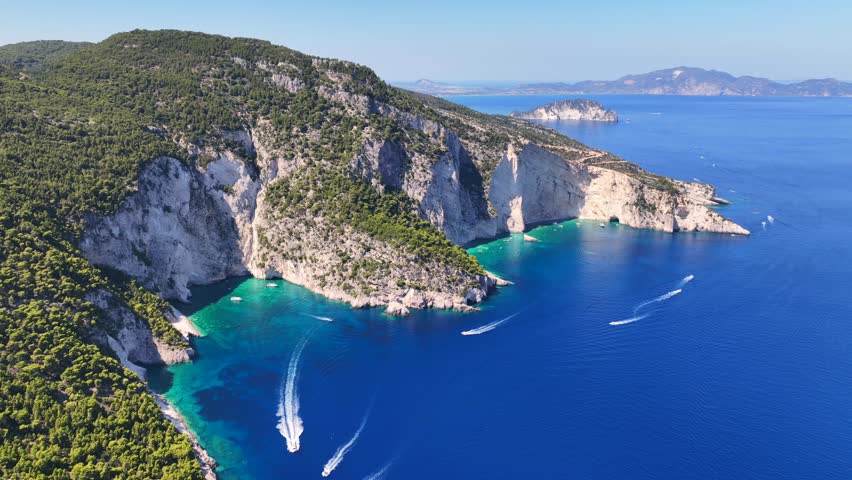 Aerial drone cinematic video of paradise sea caves of Keri with white cliffs and spectacular landscape creating a blue lagoon a true tourist attraction for yachts and boats, Zakinthos, Ionian, Greece
