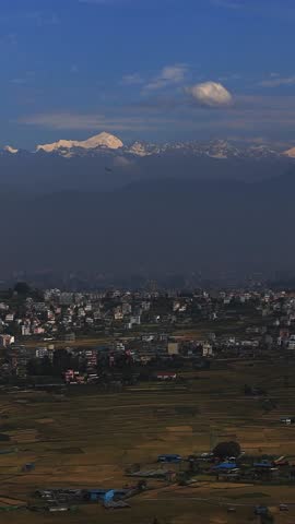 Kathmandu city and valley hills viewed from above featuring urban landscape, green slopes, flight flying ,Himalayas and wide aerial scenery representing Nepal environment and mountain region