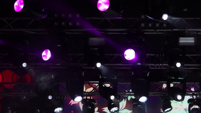 Spotlights in the concert hall. Stage light with colored spotlights and smoke.