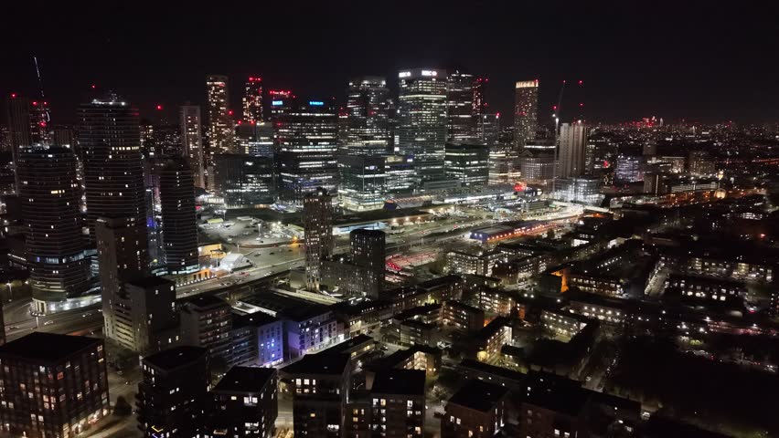 Night Canary Wharf finacial district busy highway in forground aerial push in