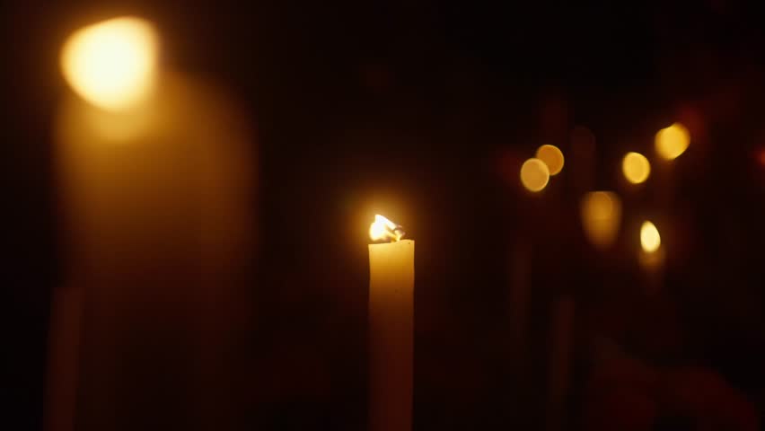 Candle lit at night for All Saints' Day. Close up