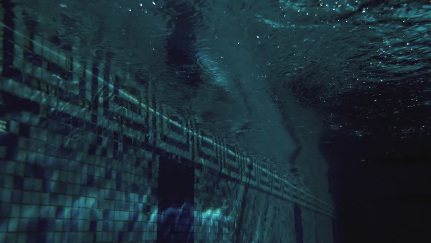 Cinematic Underwater Slow Motion of Professional Male Swimmer Performing Butterfly Turn