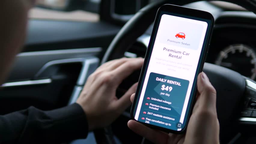 Slow motion focus on a key moment of consumer choice: evaluating the price and conditions of a car rental. Highlights comparison shopping, value assessment, and the decisive pre-purchase phase. 