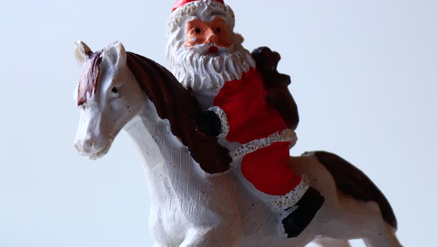 Santa Claus rides a horse, ready for holiday cheer.