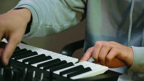 Close up of a creative musician playing and composing music on a digital synthesizer. Music producer creating an electronic track using a modern midi keyboard and adjusting the sound settings - Powered by Shutterstock - Get 15% off with code: PIKWIZARD15