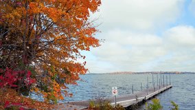 Dock on a tranquil lake in Minnetonka, surrounded by autumn trees and a cloudy sky - Powered by Shutterstock - Get 15% off with code: PIKWIZARD15