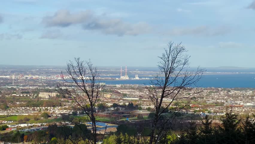 Autumn View Over The Dublin City and Coastline with Poolbeg Towers Framed by Leafless Branches