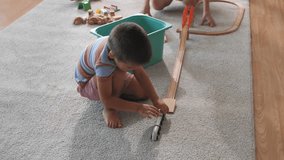 Mother and son enjoying playtime with wooden toy train, promoting creativity and family bonding - Powered by Shutterstock - Get 15% off with code: PIKWIZARD15