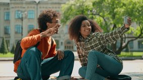 African American students sitting outside make selfie together mobile phone using smartphone ethnic couple classmates woman girl female man male guy city photo posing camera picture university college - Powered by Shutterstock - Get 15% off with code: PIKWIZARD15