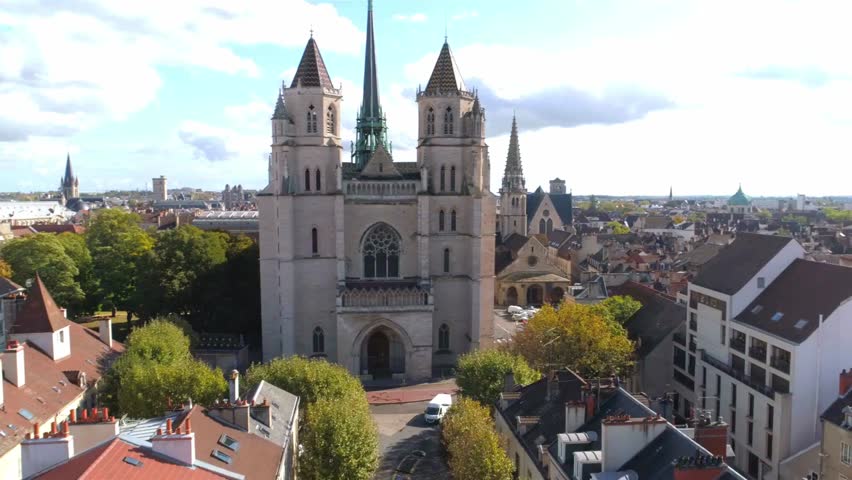 Aerial view of Dijon cityscape in Côte d'Or, Burgundy, France, showcasing historic rooftops, charming streets, and scenic urban architecture from above in golden sunlight.
