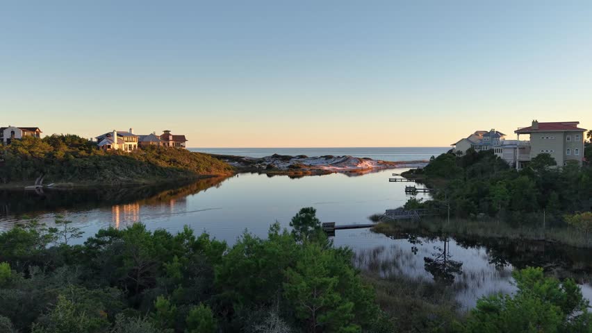 Low-altitude dynamic drone fly over Draper Lake lakeside environment towards the Gulf, Old Florida Beach, Florida, USA