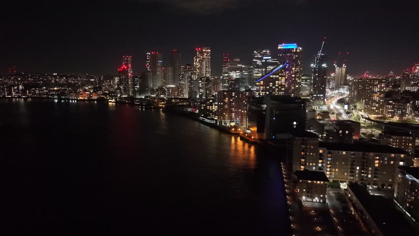 Night Canary Wharf finacial district viewed from Thames drone,aerial