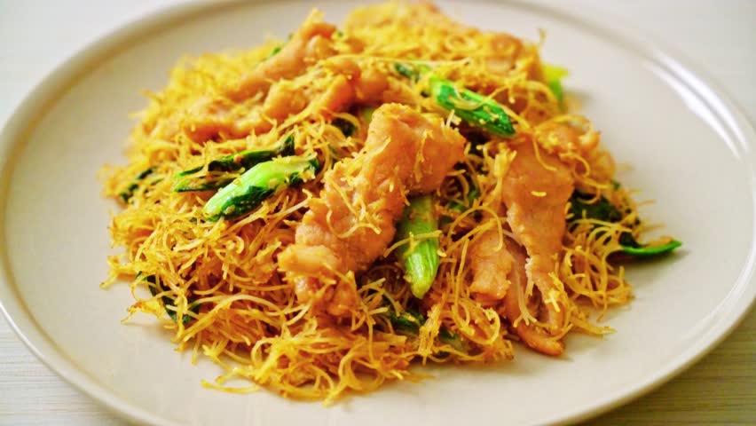 Stir-fried rice vermicelli noodles with pork and black soy sauce, served in Asian food style with aromatic seasoning and a savory, flavorful finish.