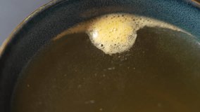 Effervescent vitamin dissolving in water as rising bubbles create a foaming reaction and gradually change the liquid color in a closeup view of the dissolving supplement process. - Powered by Shutterstock - Get 15% off with code: PIKWIZARD15