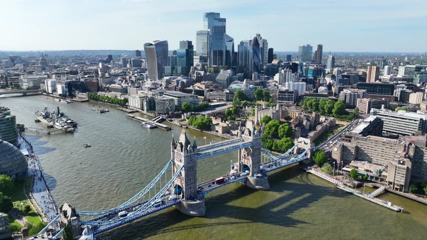 Aerial drone cinematic video of iconic Tower Bridge crossing river Thames in City of London, United Kingdom