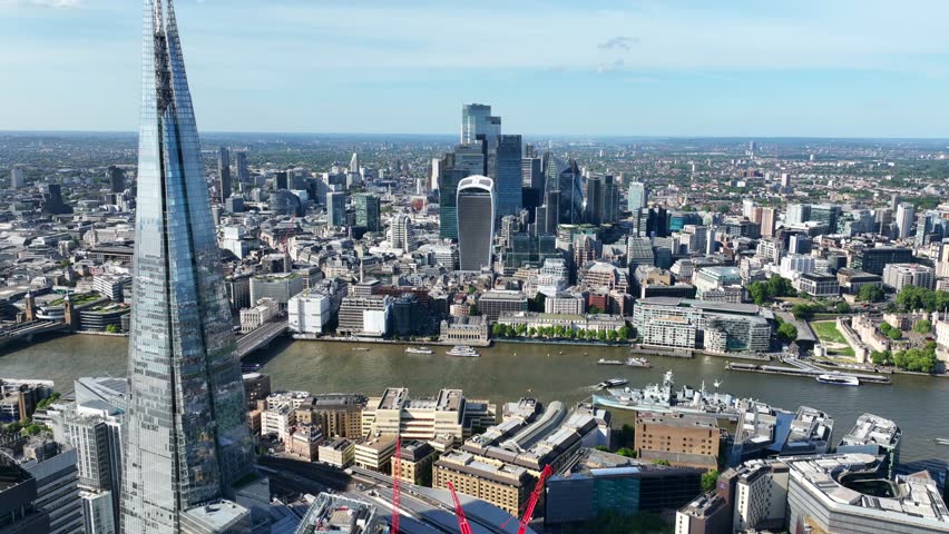 Aerial drone cinematic video of iconic landmark skyline skyscraper "The Shard" one of the tallest constructions of Europe in financial area of City of London, United Kingdom