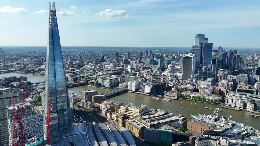 Aerial drone cinematic video of iconic landmark skyline skyscraper "The Shard" one of the tallest constructions of Europe in financial area of City of London, United Kingdom