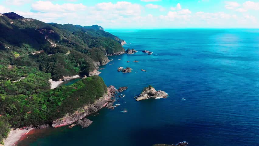 Aerial view of Shikoku’s beautiful coastline, Japan, showcasing rugged cliffs, turquoise waters, sandy beaches, and scenic landscapes along the ocean.