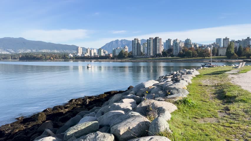 Rocky shoreline of False Creek with Vancouver skyline and North Shore mountains