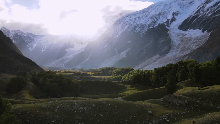 Golden Hour Aerial Over Meadows and Remote Lakeside Campsite in the Mountains