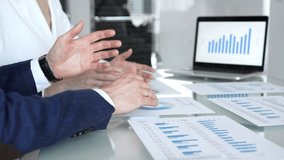 Business people collaborating on financial data analysis, reviewing growth charts on a laptop and printed reports during an important office meeting - Powered by Shutterstock - Get 15% off with code: PIKWIZARD15