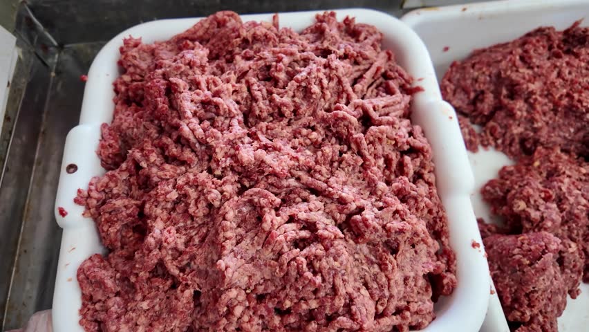 The butcher cuts the meat with a special saw. Butcher shop. Homemade.