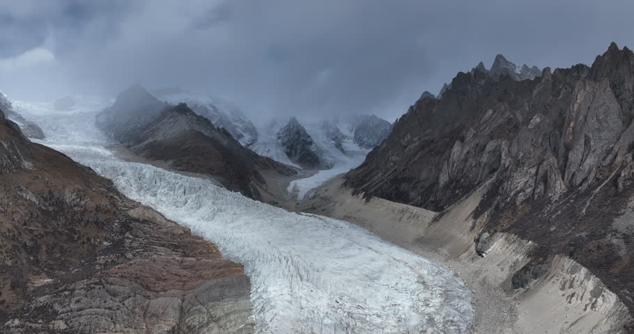 Beautiful high altitude hanging glacier and snow capped mountain with lake in Tibet, China