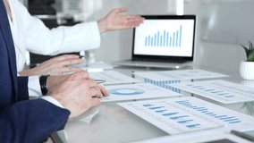 Business people hands discussing financial data and analyzing growth charts on a laptop screen during a corporate meeting with paper documents, showing teamwork and strategy planning - Powered by Shutterstock - Get 15% off with code: PIKWIZARD15