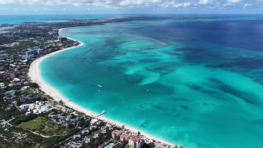 Grace Bay At Turks And Caicos In Overseas Territory United Kingdom. Caribbean Skyline. Beach Landscape. Highrise Buildings. Grace Bay In United Kingdom. Nature Background