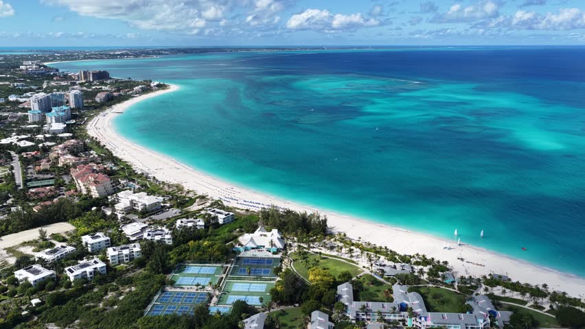 Grace Bay At Turks And Caicos In Overseas Territory United Kingdom. Caribbean Skyline. Beach Landscape. Highrise Buildings. Grace Bay In United Kingdom. Nature Background