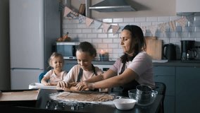 A cheerful family works together rolling ginger cookie dough at the kitchen table, sharing a warm cooperative baking moment that builds skills, connection and joyful home cooking experience concept - Powered by Shutterstock - Get 15% off with code: PIKWIZARD15