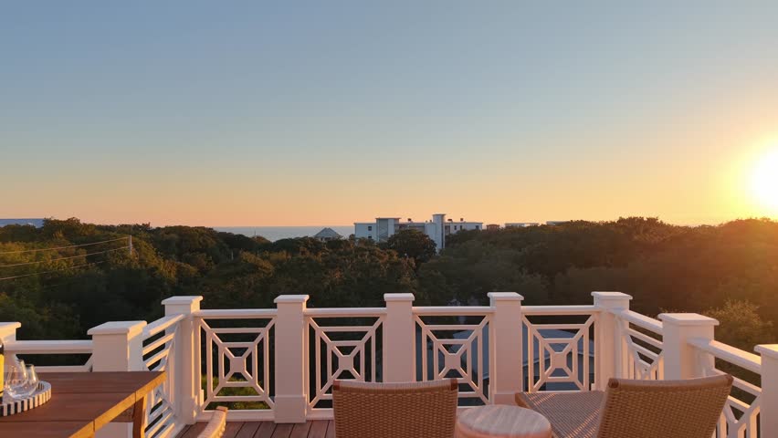 Amazing drone fly from a balcony toward magical sunset environment above residential neighborhood, 30A, Florida, USA