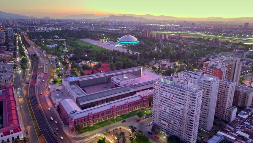 Aerial drone fly Santiago de Chile city with Bicentenario Army building and O'Higgins Park, Movistar Arena background