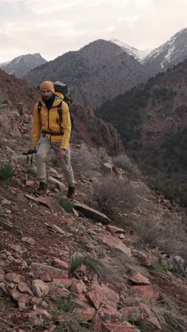 Strong solo traveler climbing snowy mountain ridge at early morning showing endurance healthy lifestyle adventure trekking motivation resilience alpine exploration outdoor focus goal achievement