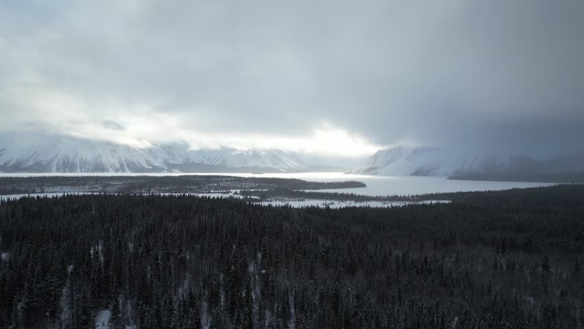 Aerial approaches a snow-covered, frozen Kathleen Lake toward the majestic King