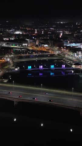 Wide overhead 4K 60 frames per second social ratio aerial video of Belfast City Centre in Northern Ireland at night. Produced with broadcast standard Rec709 color space.