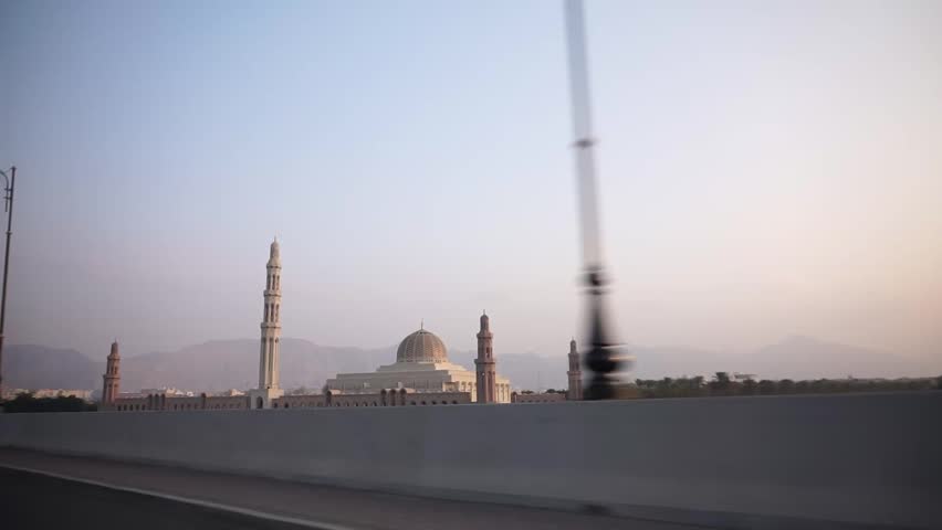 Cinematic exterior view of the Sultan Qaboos Grand Mosque in Muscat, Oman, showcasing Islamic architecture and a popular Middle Eastern travel landmark.
