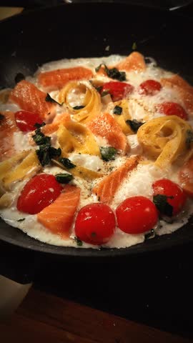 Pan-fried salmon pasta with juicy cherry tomatoes and sauce