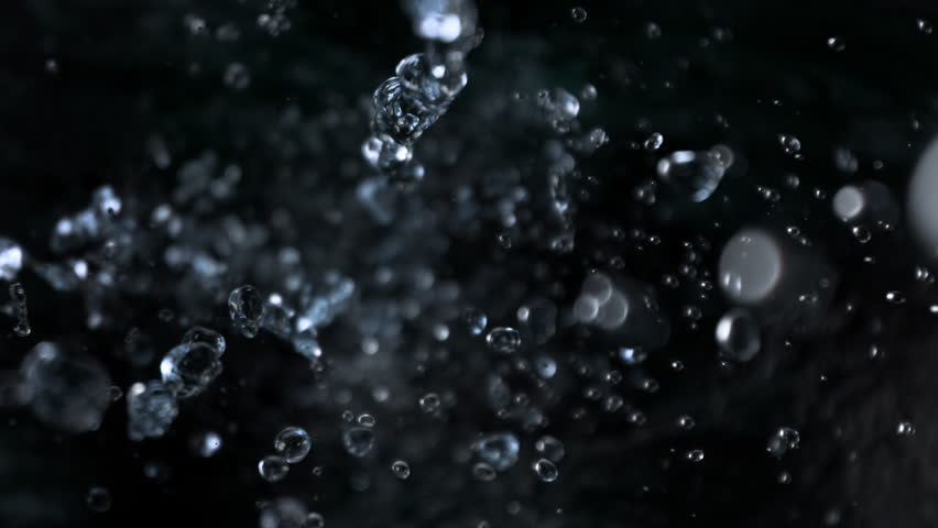 Super Slow Motion Shot of Falling Water Drops on Black Background at 1000fps.