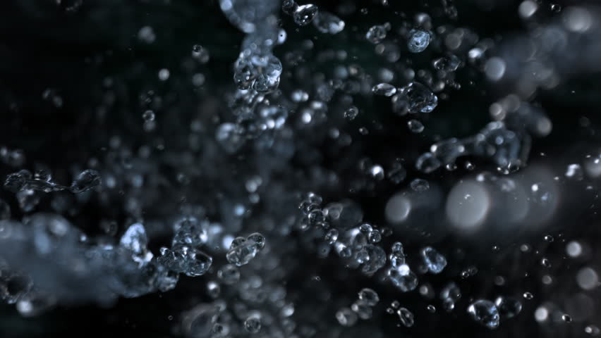 Super Slow Motion Shot of Falling Water Drops on Black Background at 1000fps.