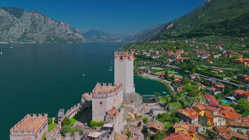 Aerial view of Castello Scaligero di Malcesine on Lake Garda with summer landscape, mountains, alpine shoreline and scenery in Northern Italy, recognized as one of the Borghi piu belli d Italia.