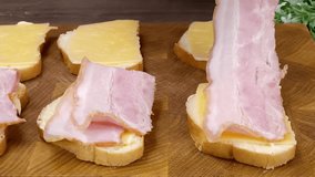 A person prepares a delicious bacon and cheese sandwich by layering ingredients on white bread slices - Powered by Shutterstock - Get 15% off with code: PIKWIZARD15
