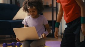 African American siblings in activewear typing on laptop, having fun at home - Powered by Shutterstock - Get 15% off with code: PIKWIZARD15