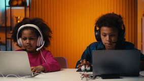 African American siblings playing racing game on laptops, fun competition - Powered by Shutterstock - Get 15% off with code: PIKWIZARD15