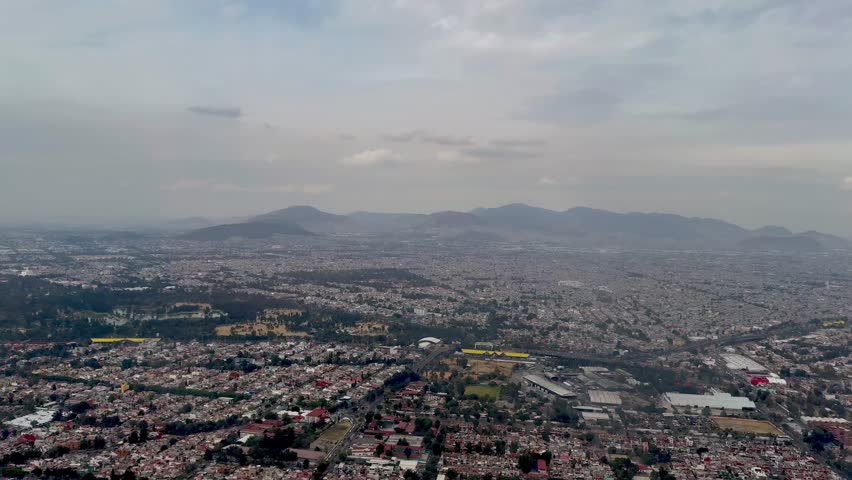 Aerial view of Mexico City, with the mountain range in the background