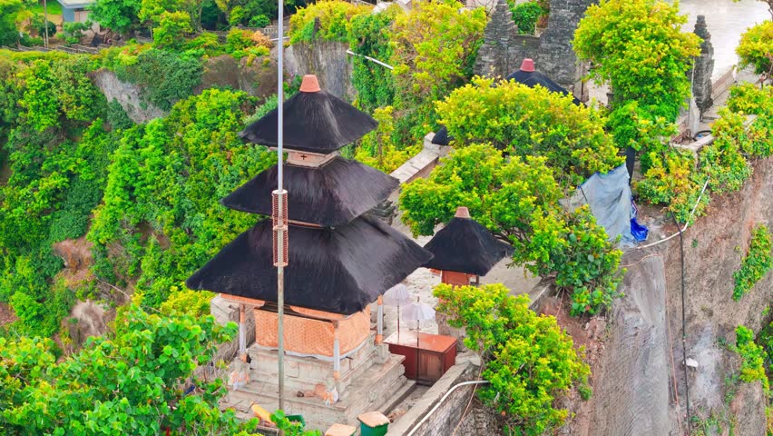 Uluwatu Temple Bali one of six key Bali temple perched on top mountain cliff on nature background Bali, Indonesia 4K Aerial view