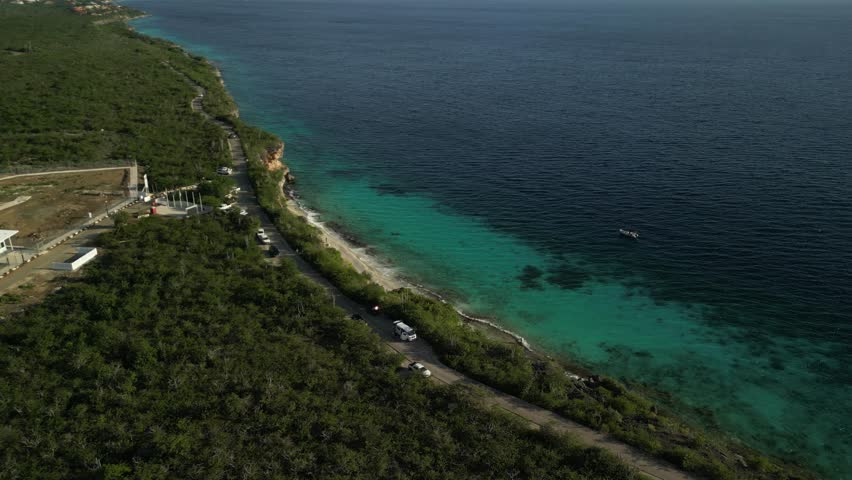 Expansive look at shoreline, reef, green areas, and open blue waters. Versatile for tourism ads, landscape videos, and stock usage